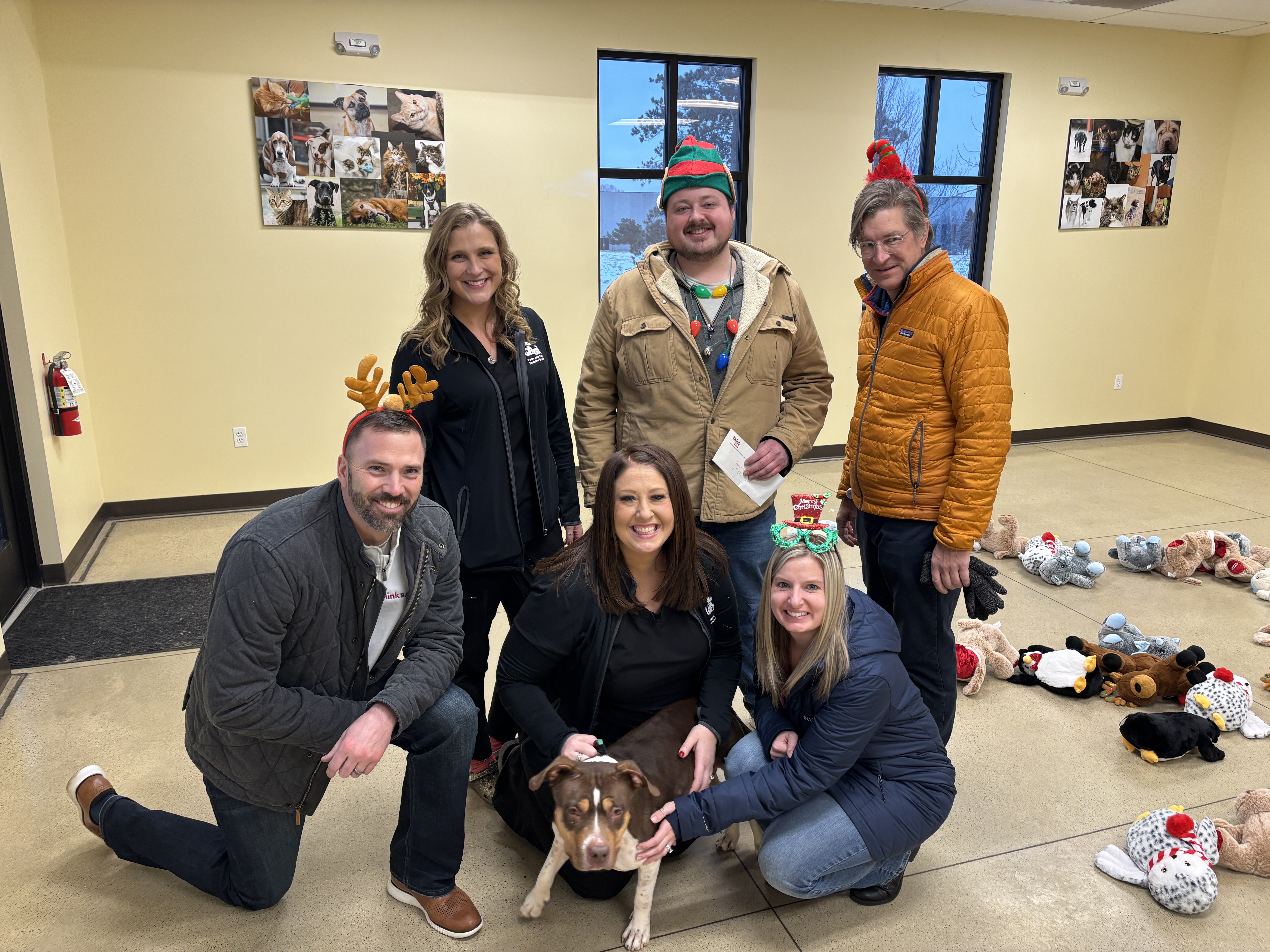 Teammates posing with a dog