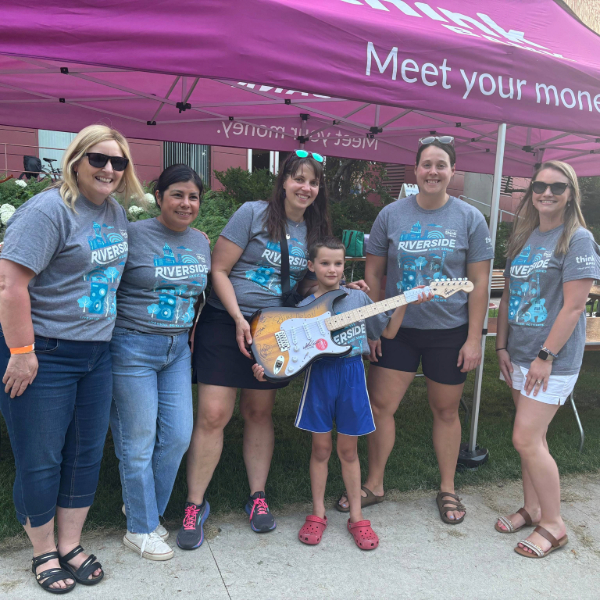 A group posing with a guitar 