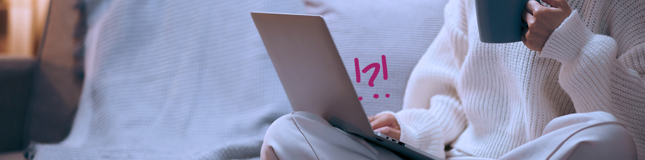 Person using a laptop with a warning symbol on the screen, illustrating online phishing and scam activity