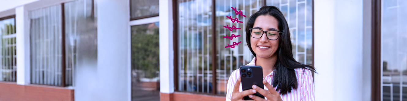 Person using a smartphone to manage banking outside a branch building