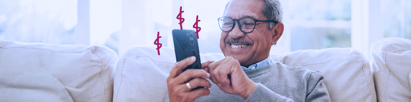 A person sitting on a couch banking on their phone