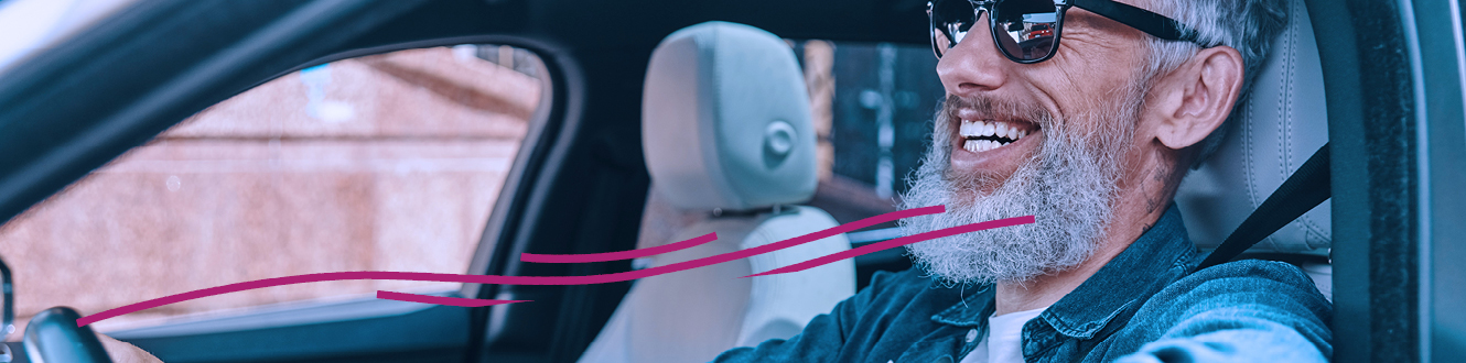 A person enjoying a drive in a car with the windows open 